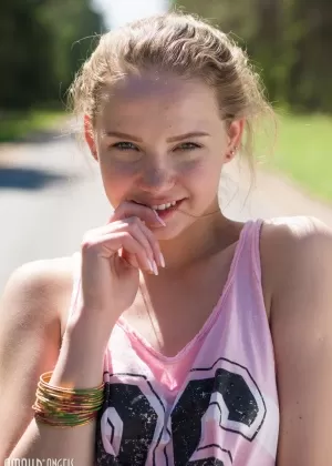 Young blonde girl Faina gets naked in middle of road wearing roller blades