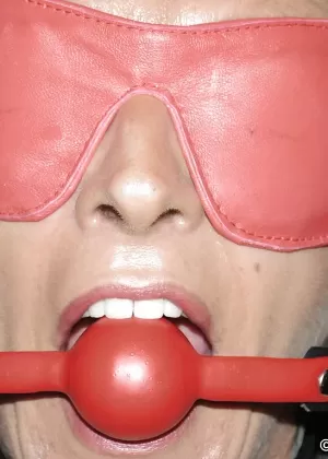 Mature submissive woman Lady Sarah poses in variety of restraining devices