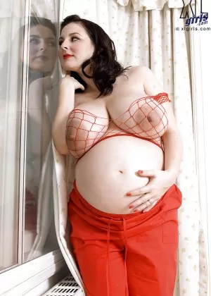 Brunette preggo with fat tits Lorna Morgan posing in fishnet bra and black panties