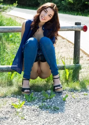 Молоденькая брюнетка Эвита Лима демонстрирует свои большие натуральные сиськи на дороге