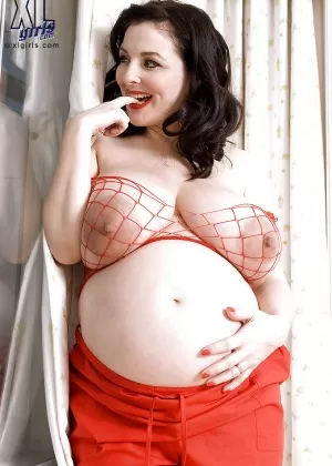 Brunette preggo with fat tits Lorna Morgan posing in fishnet bra and black panties