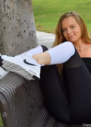Young redhead Mandy slides legging over her phat ass during solo action