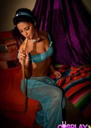 Solo girl Nicola Kiss puffs on a hookah pipe while masturbating in a tent